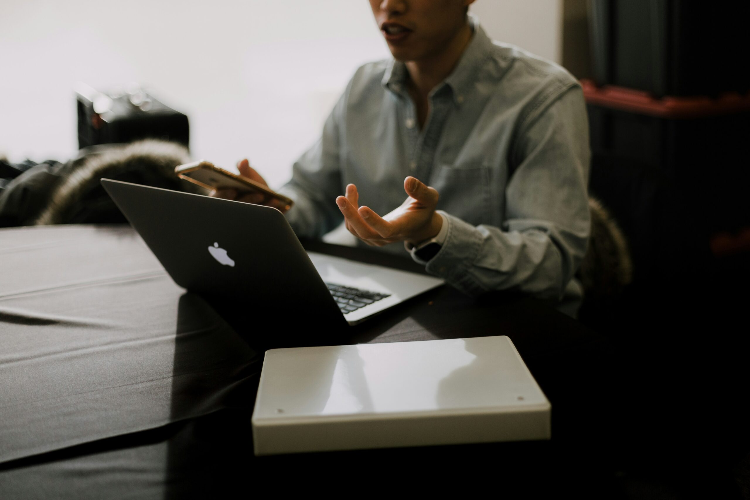 A laptop open with spreadsheets showing various freelancing invoices