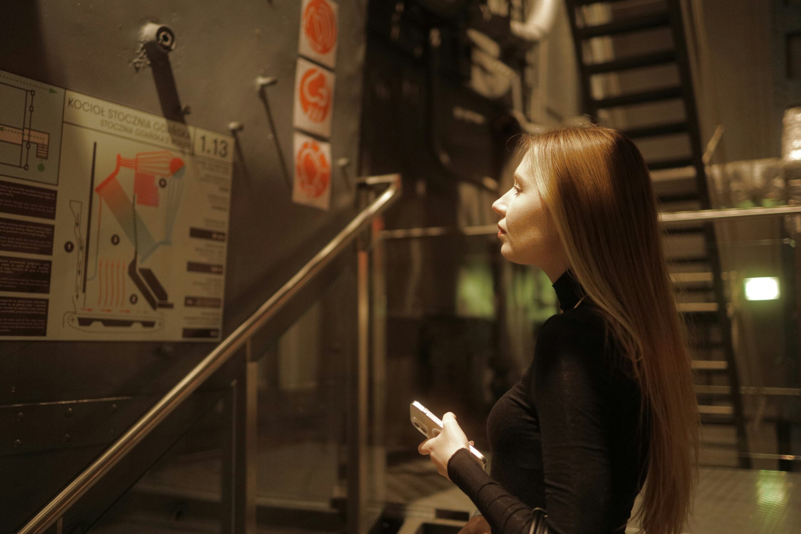 A woman speaking over the phone to customer service while taking notes