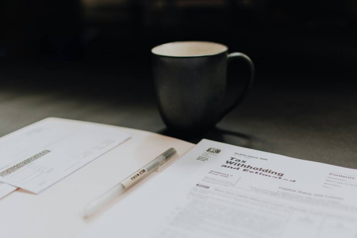 Close-up shot of someone filling out a printed document with pen